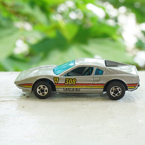 1982 Vintage HOT WHEELS Ferrari Racebait 308 Turbo SIlver Car with Red and Yellow Detail. Made by Mattel, Inc.